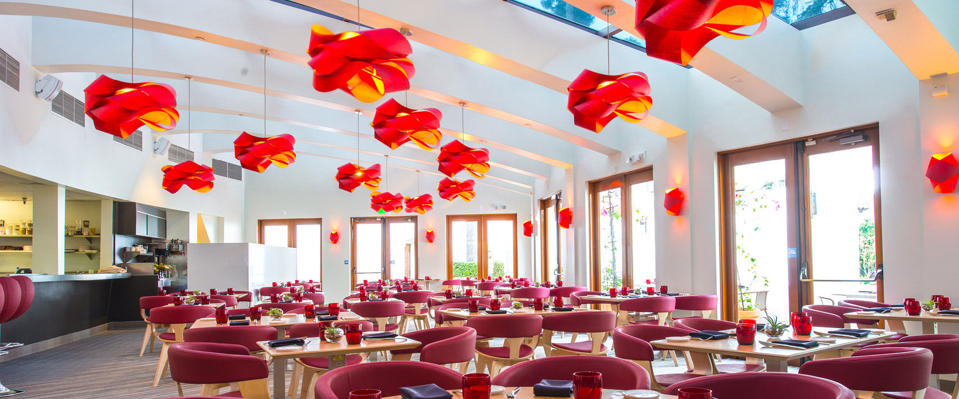 Interior shot of restaurant with red and orange chandeliers.